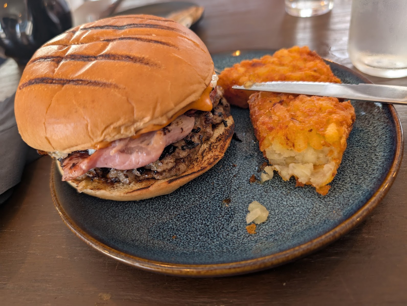 Close-up of a grilled burger with hash browns on a plate at The Burlam Bear in Middlesbrough