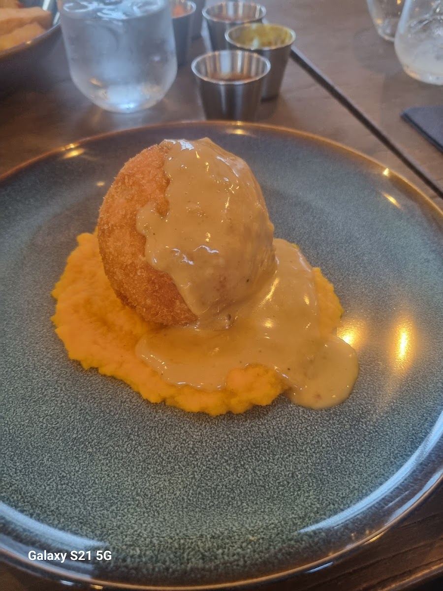 A plated gourmet croquette with creamy sauce and mash at The Burlam Bear in Middlesbrough